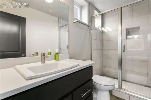 a bathroom with a sink toilet and shower