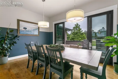 a view of a dining room with furniture and chandelier