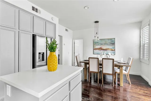 a kitchen with a table chairs and a refrigerator