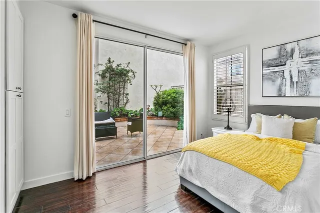 a spacious bedroom with a bed and a large window