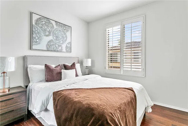 a large bed sitting in a bedroom next to a window