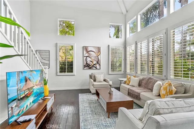 a living room with fireplace furniture and a large window