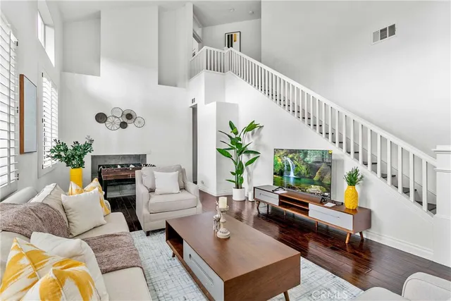a living room with furniture and a potted plant