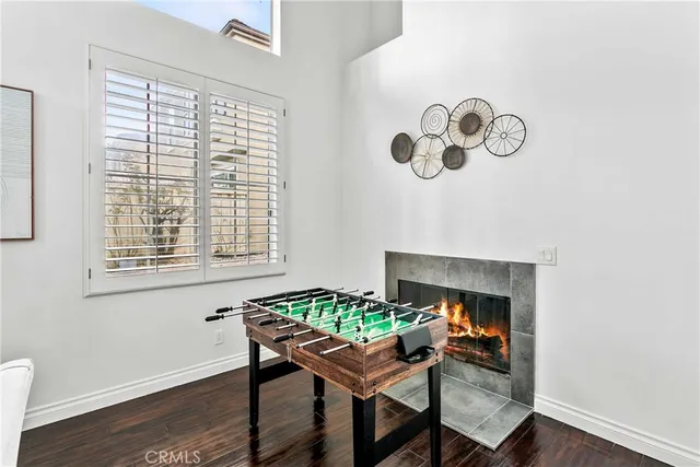 a dining room with furniture a fireplace and wooden floor