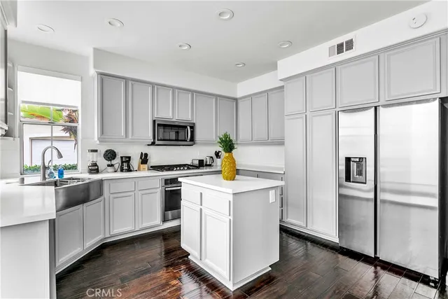 a kitchen with white cabinets and white appliances