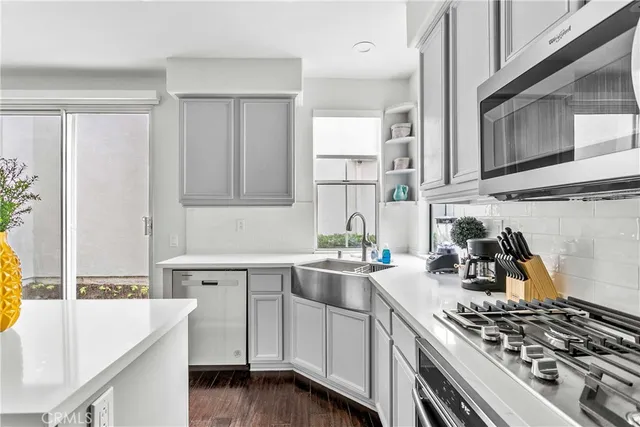 a kitchen with a sink stove and cabinets