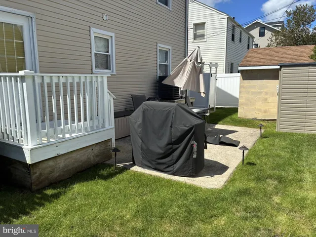 a view of backyard with a chair and a garden