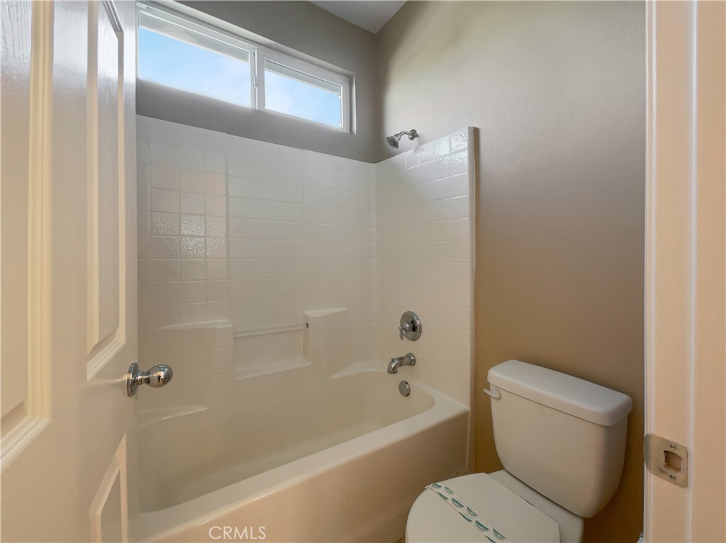 28872 Cedar Brook Lane Menifee, CA 92584 - Photo 19 of 26 a white toilet sitting next to a bath tub