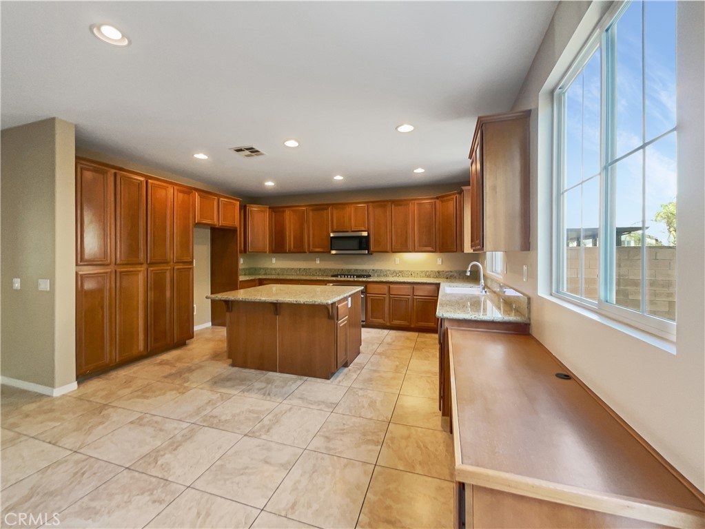 28872 Cedar Brook Lane Menifee, CA 92584 - Photo 26 of 26 a kitchen with stainless steel appliances granite countertop a refrigerator a sink and a stove