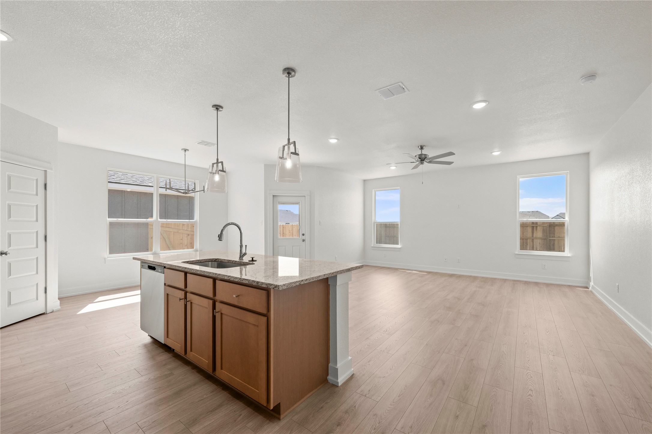 544 Gus Loop Georgetown, TX 78626 - Photo 10 of 22 a kitchen with stainless steel appliances granite countertop a sink a stove and a wooden floors