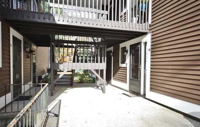 a view of a patio with a table and chairs and potted plants