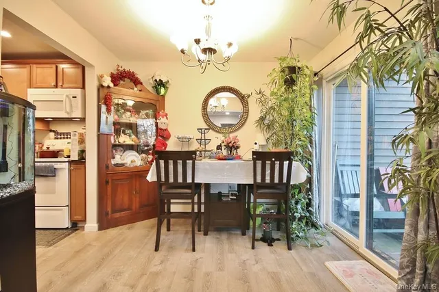 a view of a dining room with furniture and a chandelier