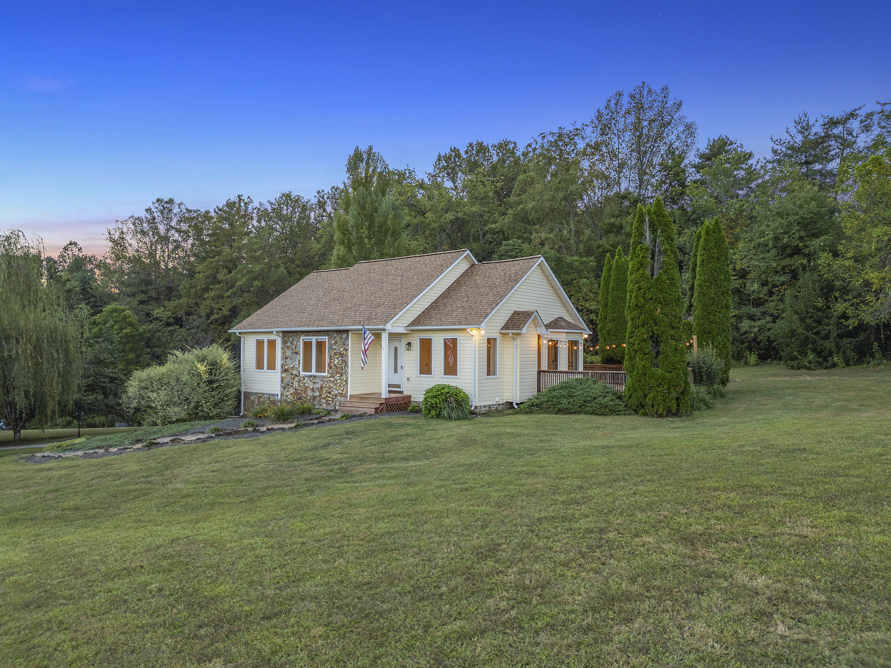 885 Whetstone Road Ferrum, VA 24088 - Photo 2 of 64 a house that is sitting in the grass with large trees