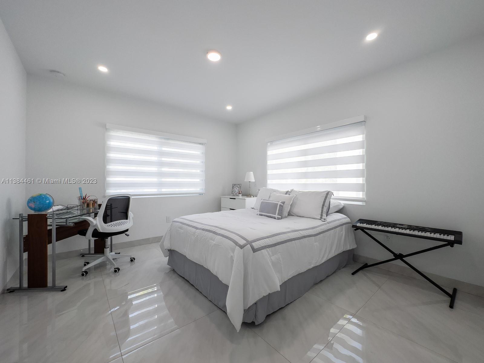 420 Southwest 18th Road Miami, FL 33129 - Photo 13 of 30 a bedroom with a bed and a window