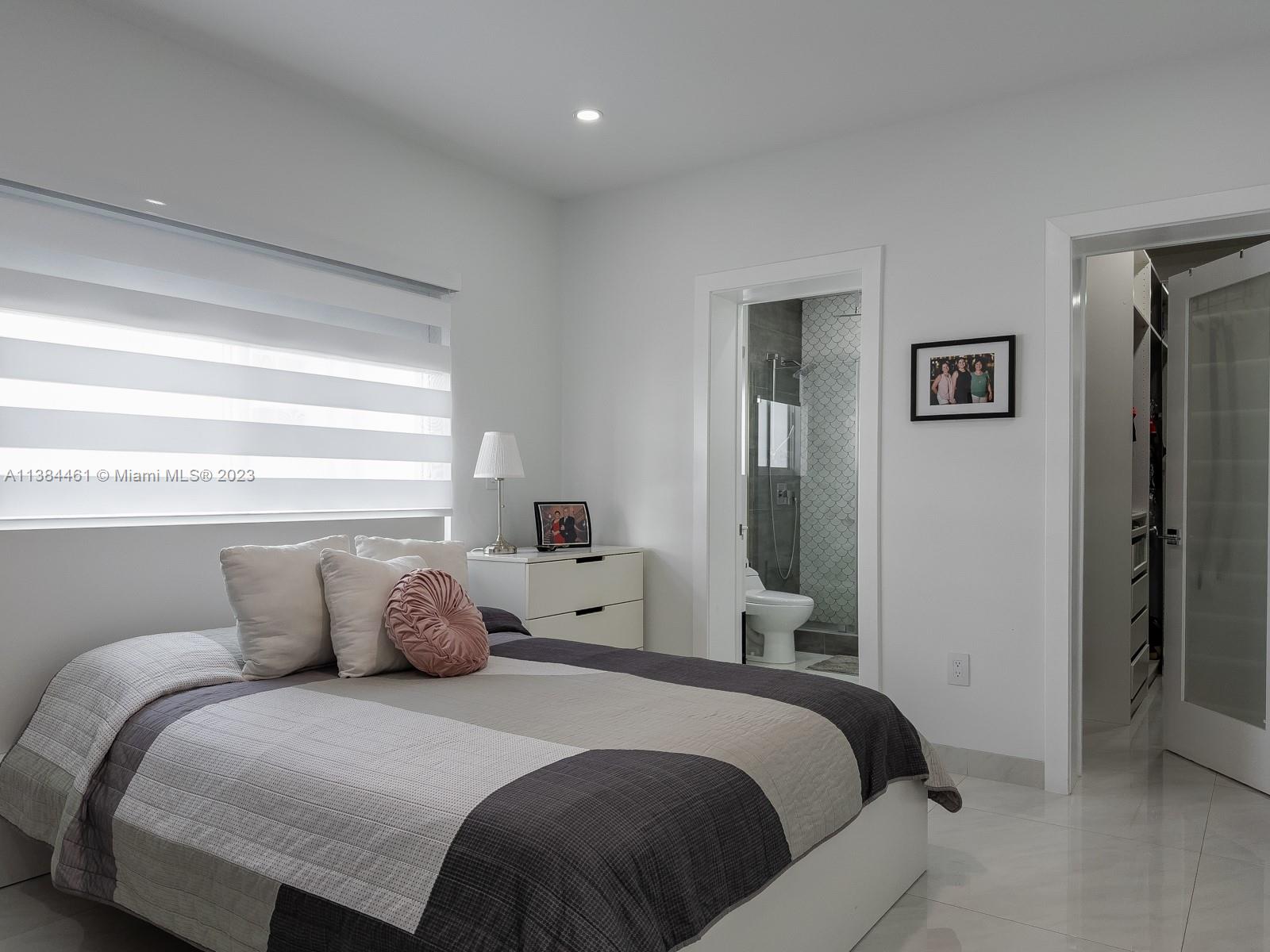 420 Southwest 18th Road Miami, FL 33129 - Photo 17 of 30 a bedroom with a bed and window