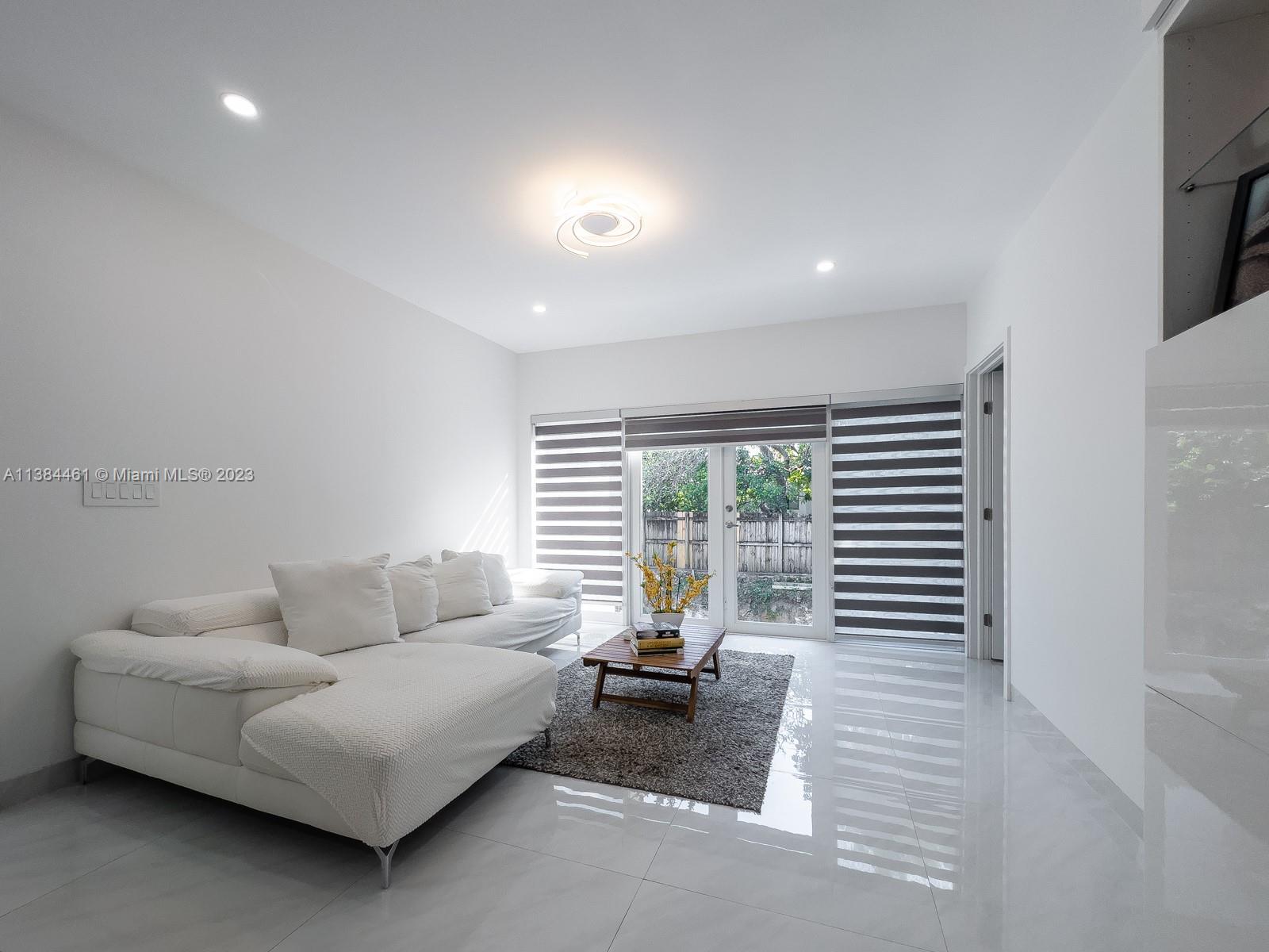 420 Southwest 18th Road Miami, FL 33129 - Photo 20 of 30 a living room with furniture and large windows