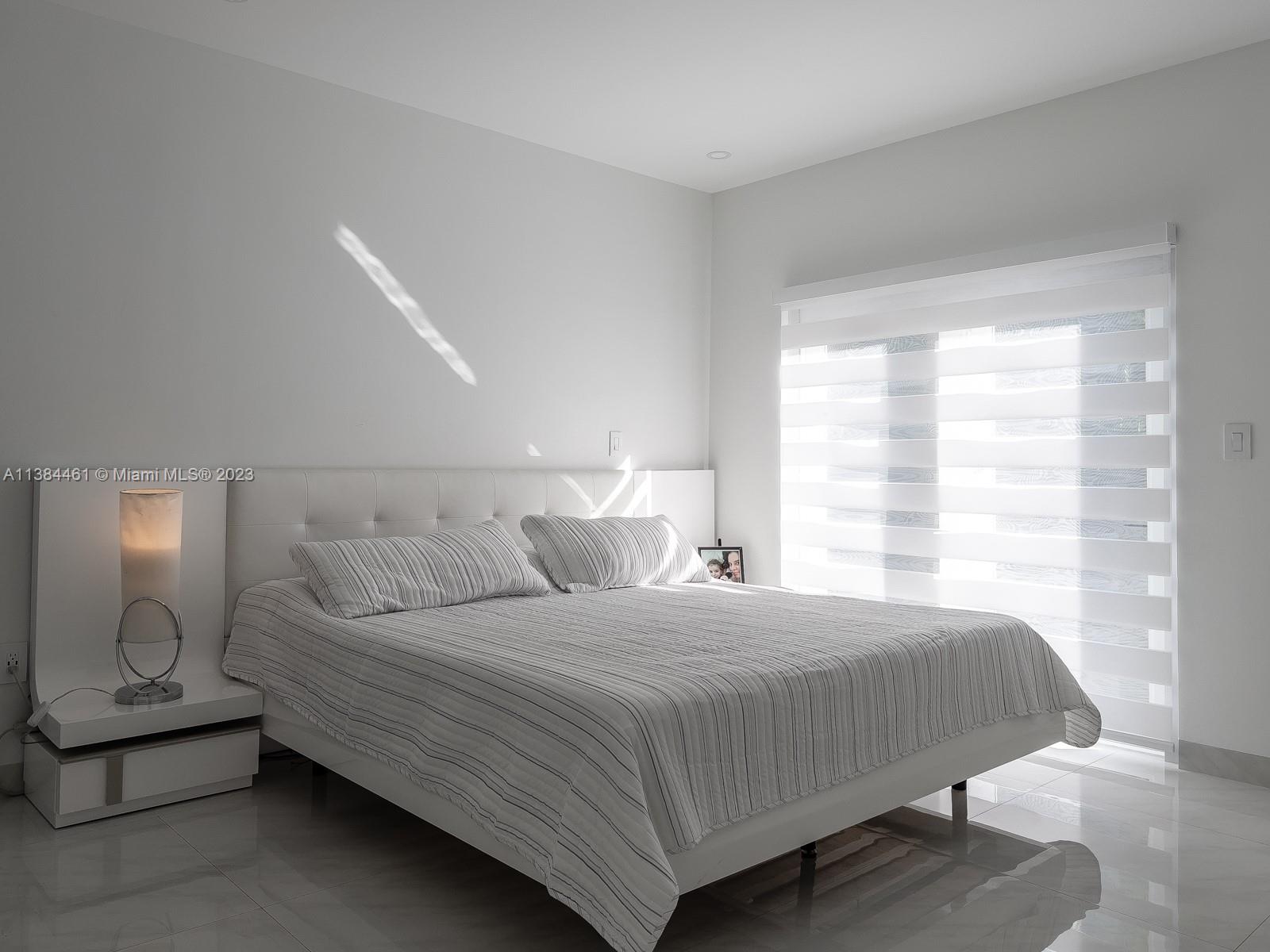 420 Southwest 18th Road Miami, FL 33129 - Photo 22 of 30 a bedroom with a bed and window