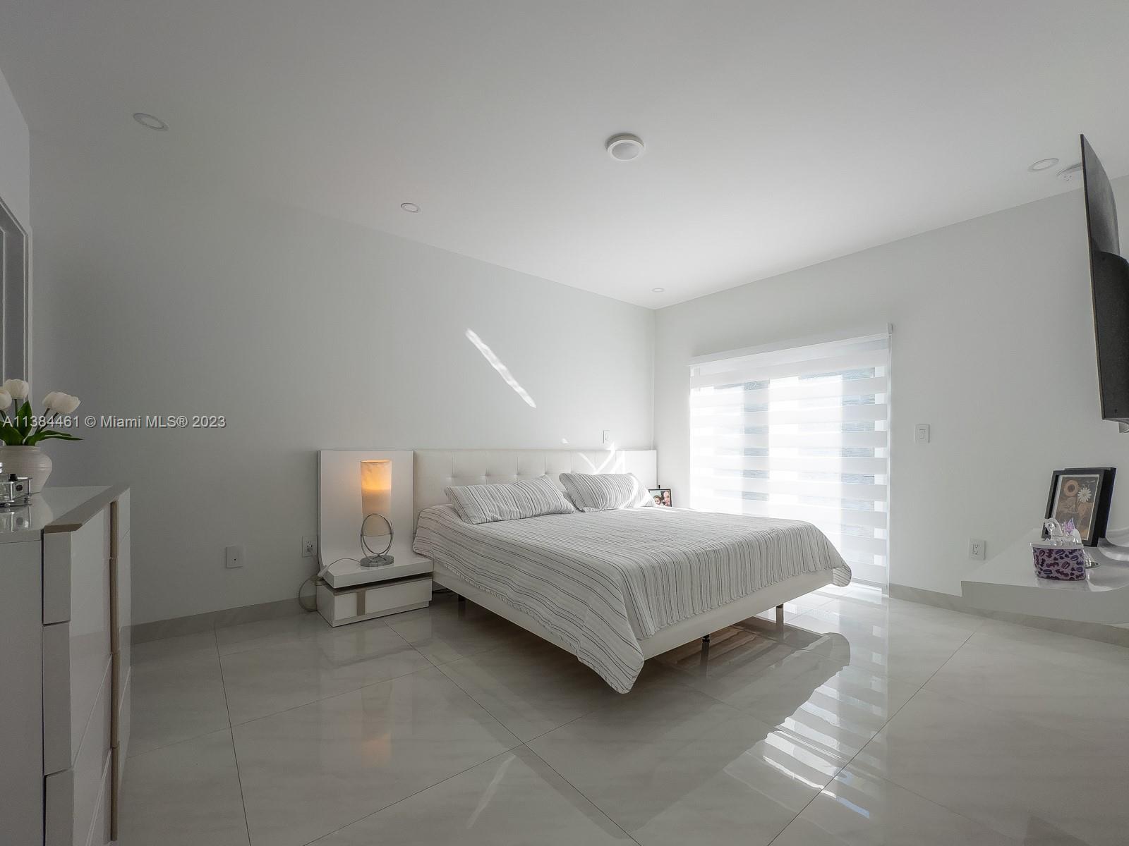 420 Southwest 18th Road Miami, FL 33129 - Photo 23 of 30 a bedroom with a bed and a couch