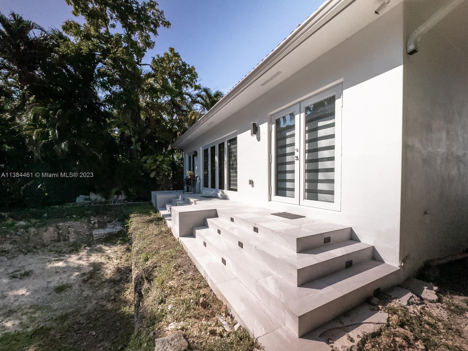 420 Southwest 18th Road Miami, FL 33129 - Photo 27 of 30 a view of white house with a yard