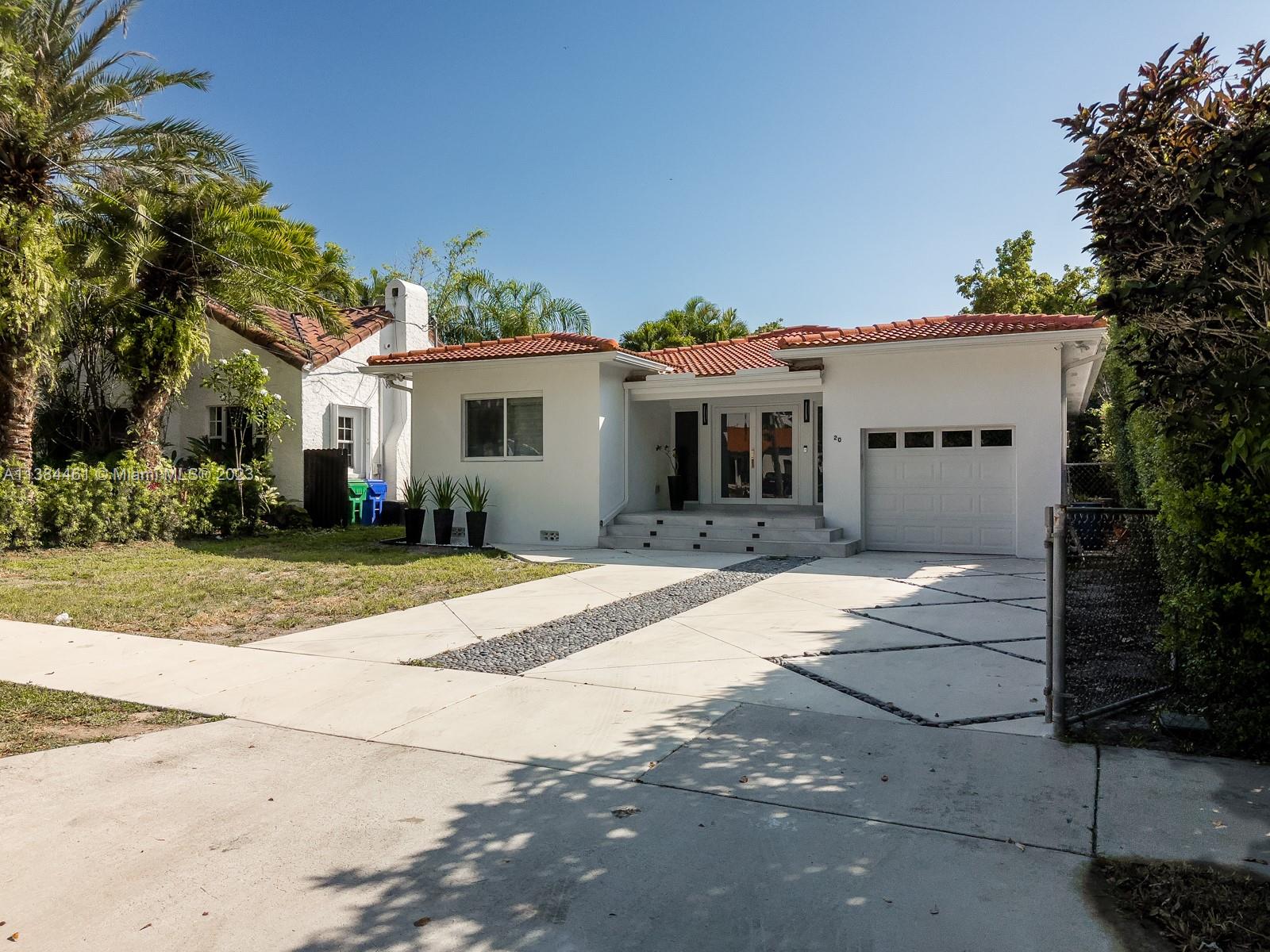 420 Southwest 18th Road Miami, FL 33129 - Photo 3 of 30 a front view of a house with a yard and garage