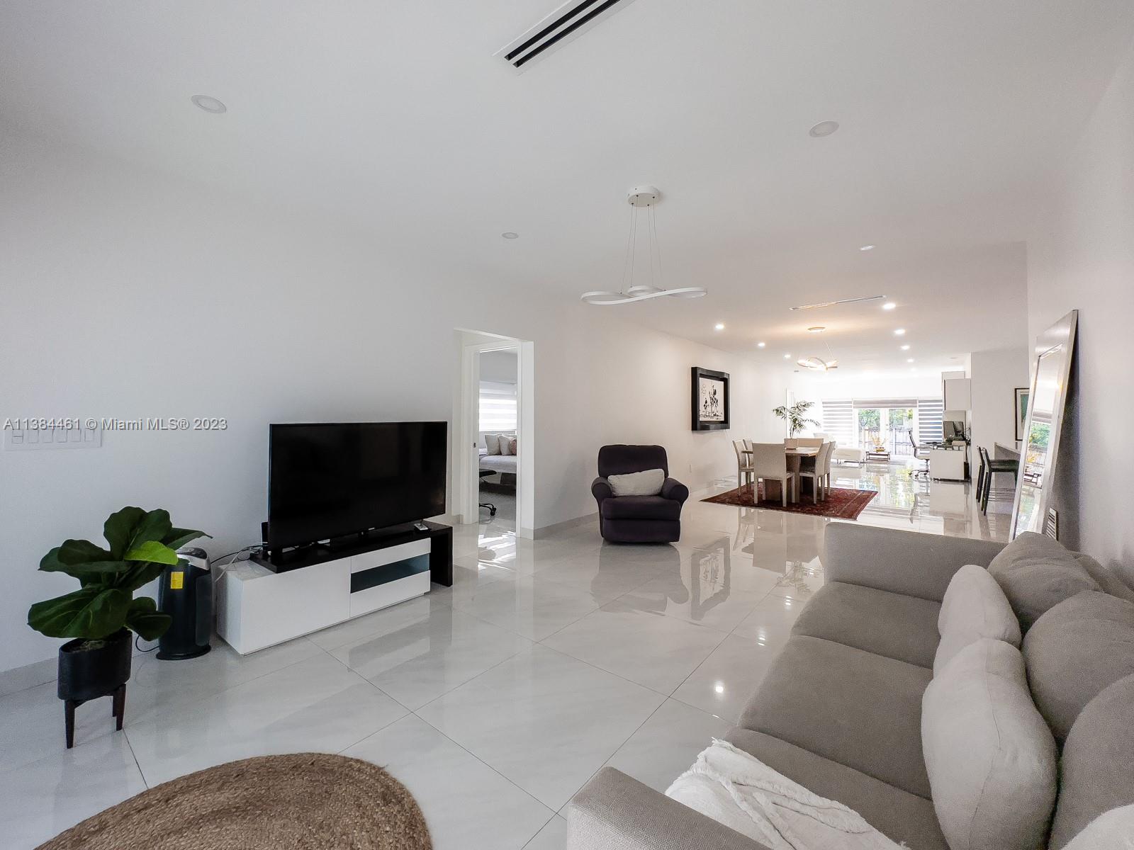 420 Southwest 18th Road Miami, FL 33129 - Photo 5 of 30 a living room with furniture and a flat screen tv