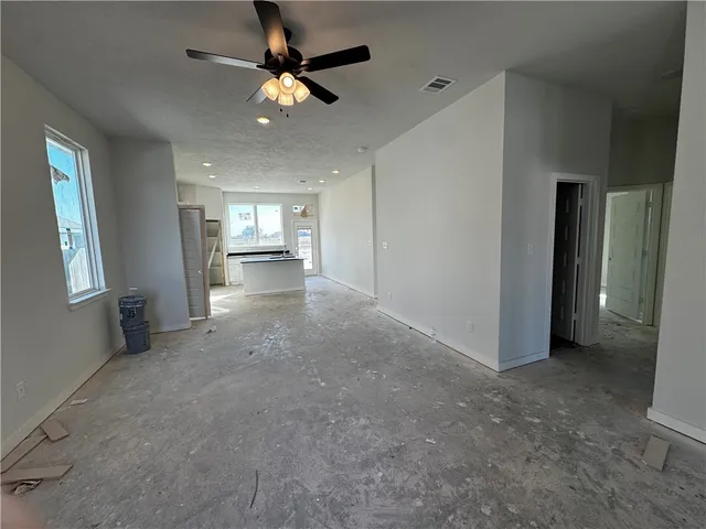 a view of a livingroom with a ceiling fan and window