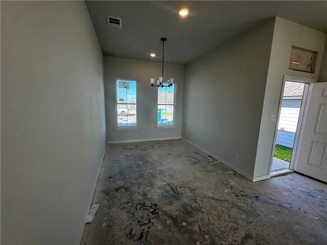an entryway in a room with windows and hallway
