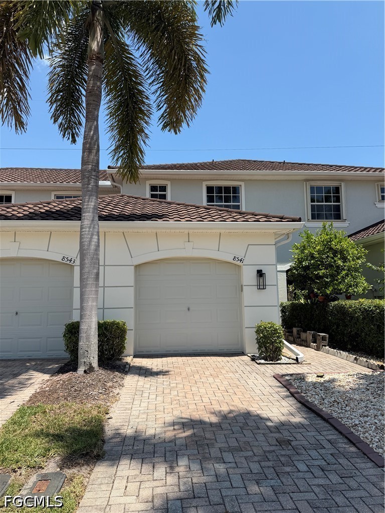 8541 Athena Court Lehigh Acres, FL 33971 - Photo 1 of 17 a front view of a house with a yard