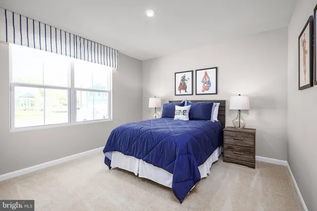 a spacious bedroom with a bed and a window