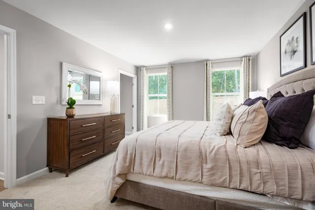 a bedroom with a bed and window with chair