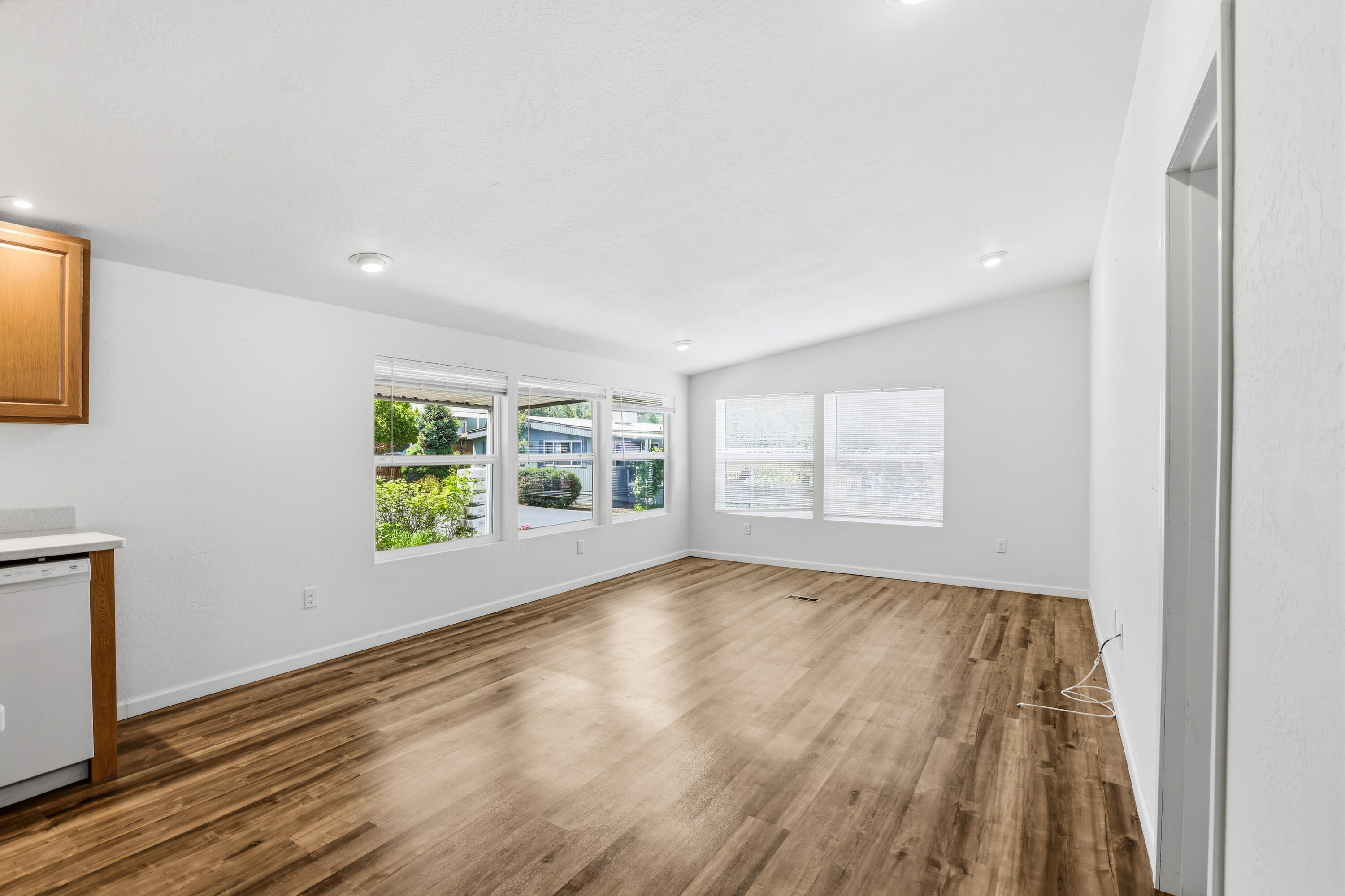8401 Old Stage Road, Unit 16 Central Point, OR 97502 - Photo 12 of 23 a view of an empty room with a window and wooden floor