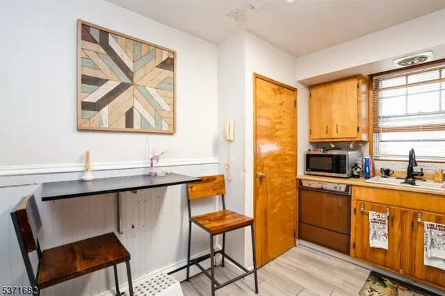 a kitchen with stainless steel appliances a stove a sink and a refrigerator