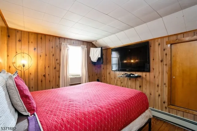 a bed room with a bed and a television