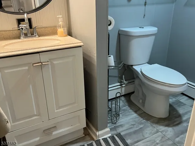 a bathroom with a toilet a sink and a mirror