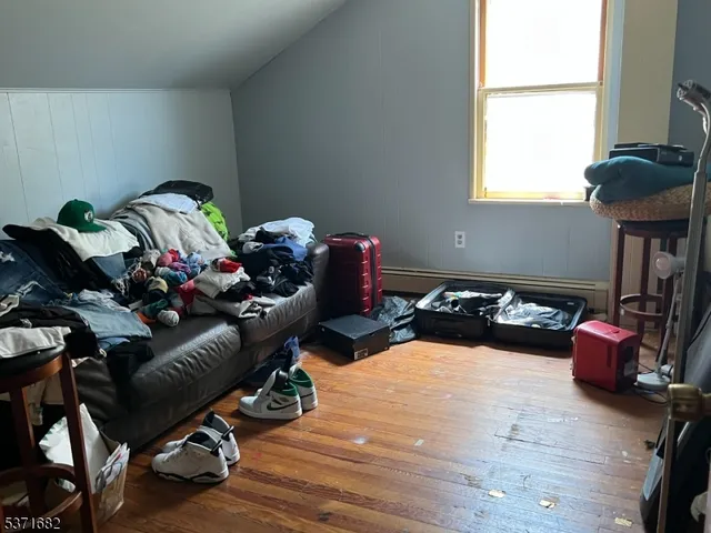 a bedroom with furniture toys and a window