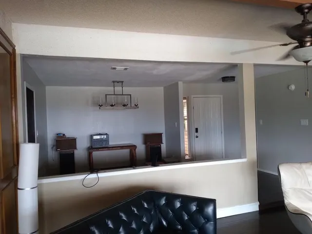 a view of a workspace with furniture and wooden floor