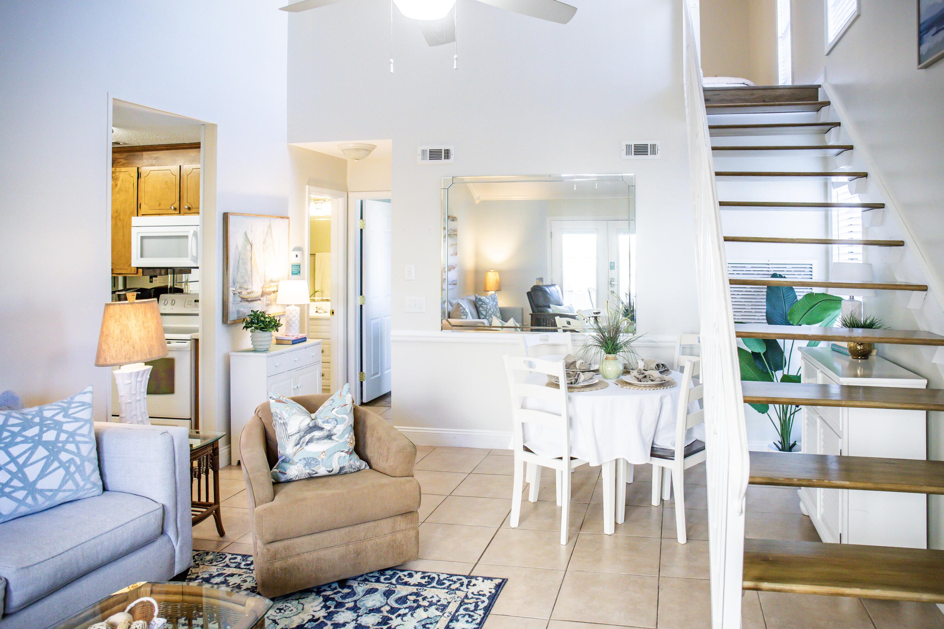 17462 Front Beach Road, Unit 38B Panama City Beach, FL 32413 - Photo 11 of 39 a view of a dining room with furniture and a rug