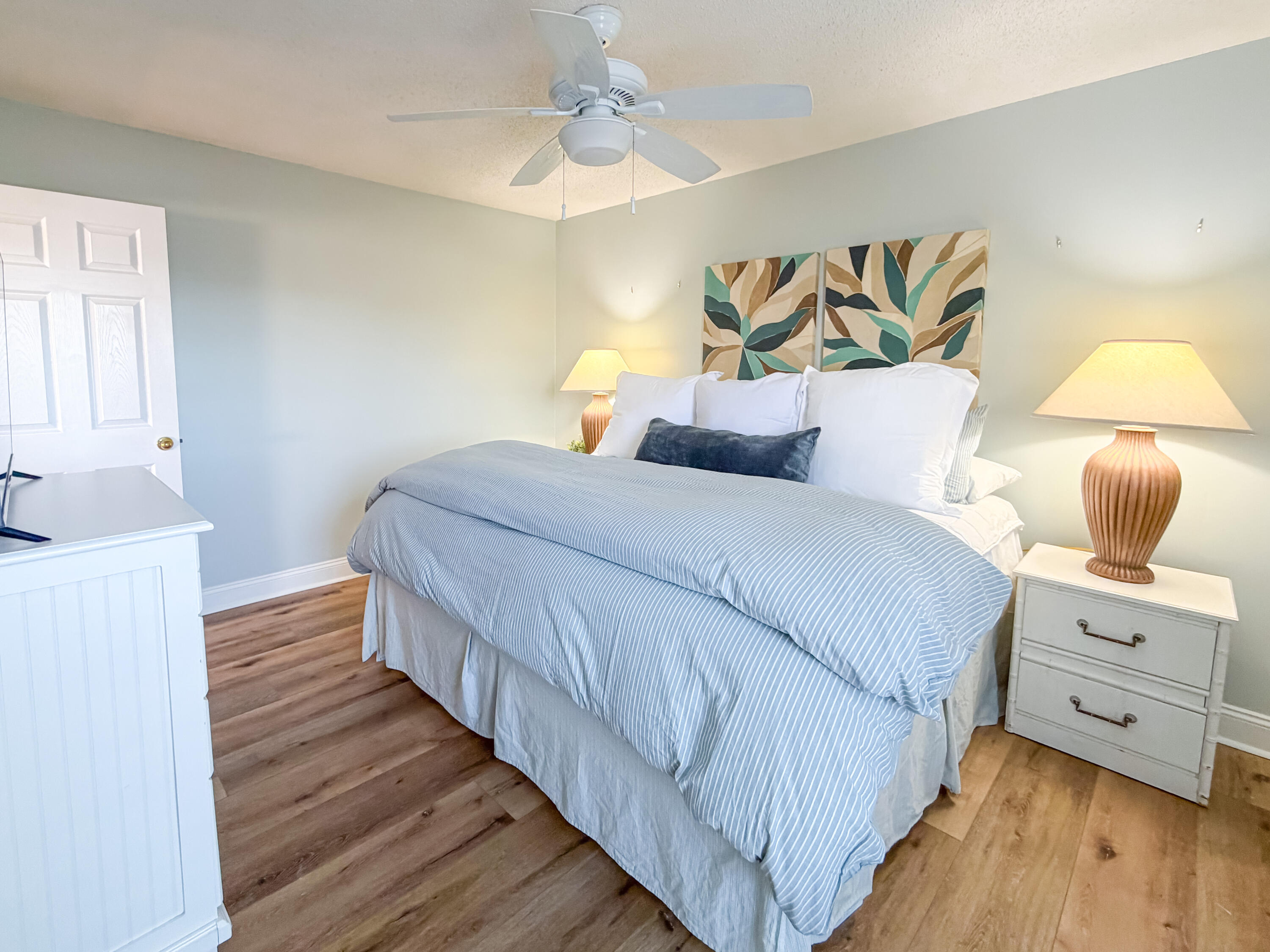 17462 Front Beach Road, Unit 38B Panama City Beach, FL 32413 - Photo 16 of 39 a bedroom with a bed and wooden floor