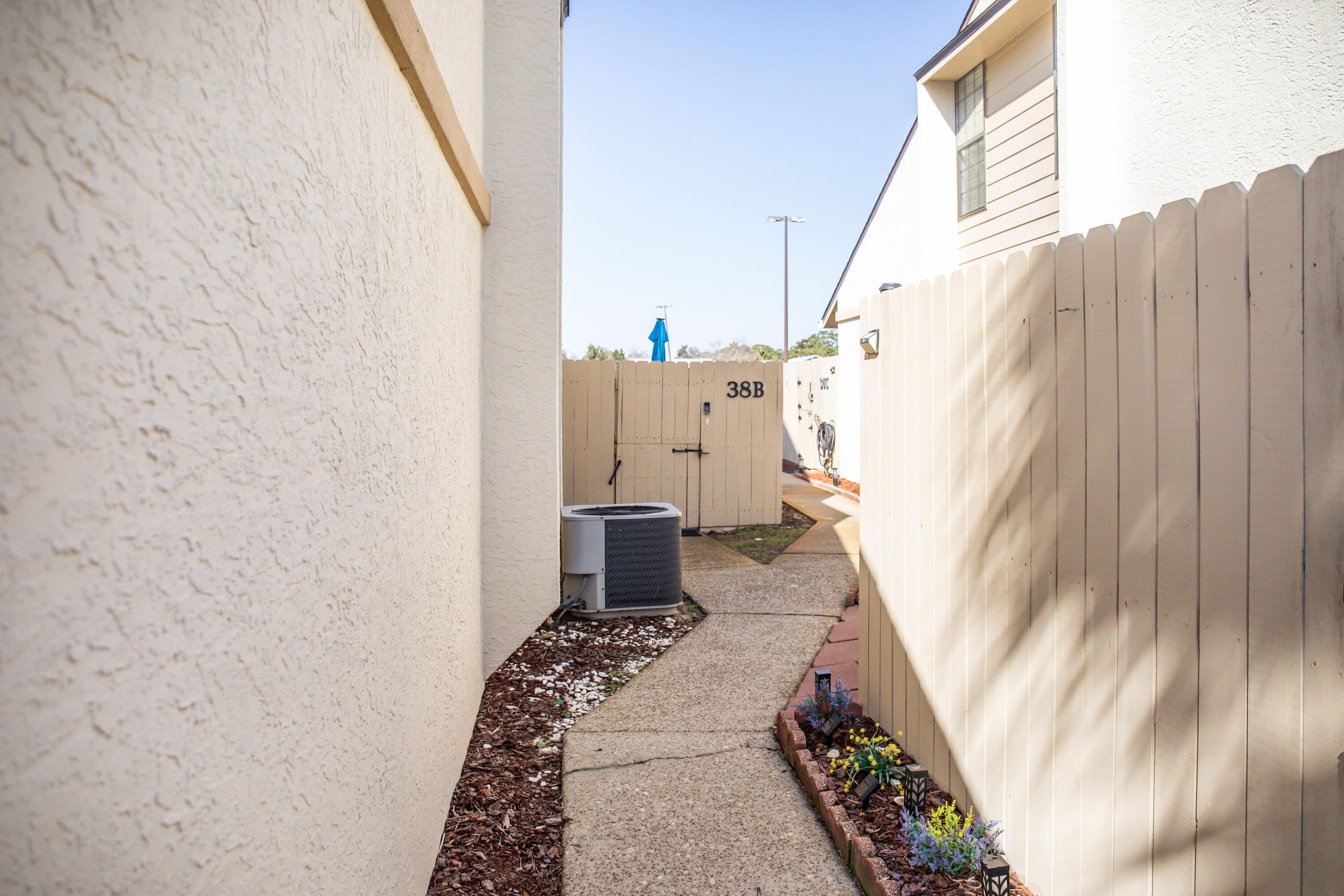 17462 Front Beach Road, Unit 38B Panama City Beach, FL 32413 - Photo 28 of 39 a view of a bedroom with wooden floor and stairs