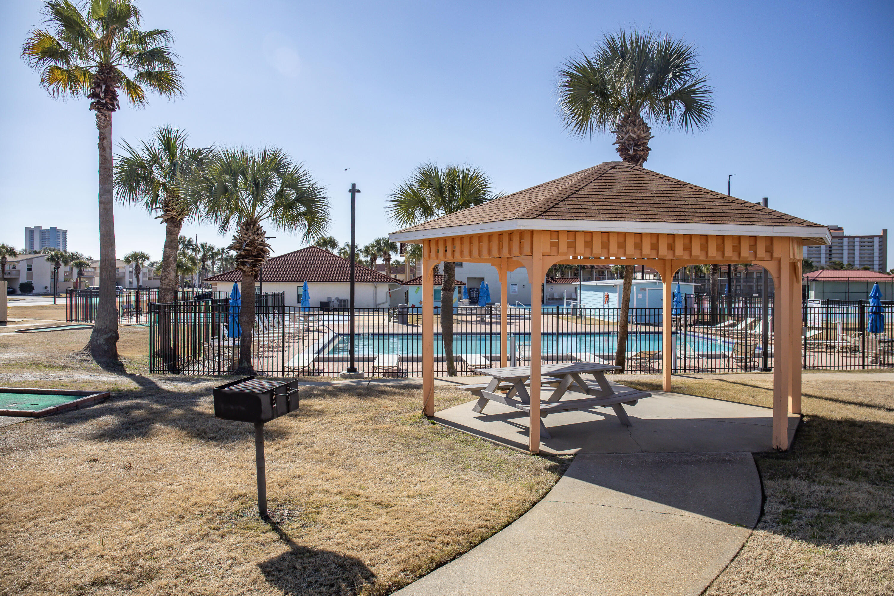 17462 Front Beach Road, Unit 38B Panama City Beach, FL 32413 - Photo 34 of 39 a swimming pool with outdoor seating