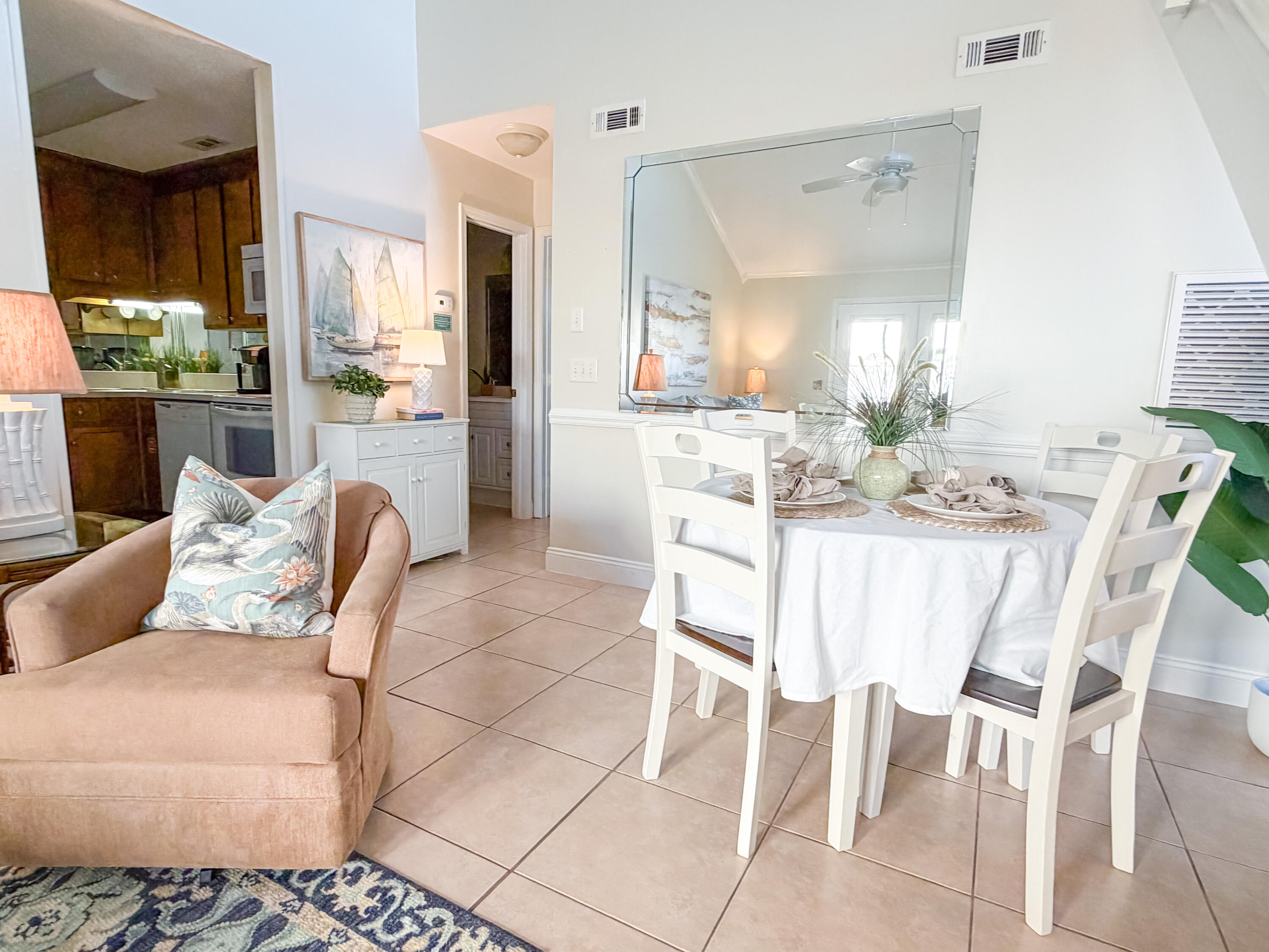 17462 Front Beach Road, Unit 38B Panama City Beach, FL 32413 - Photo 4 of 39 a dining room with furniture a large window and kitchen view