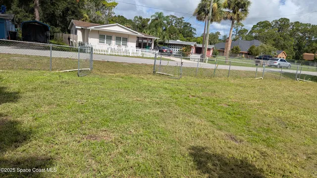a house view with swimming pool in front of it
