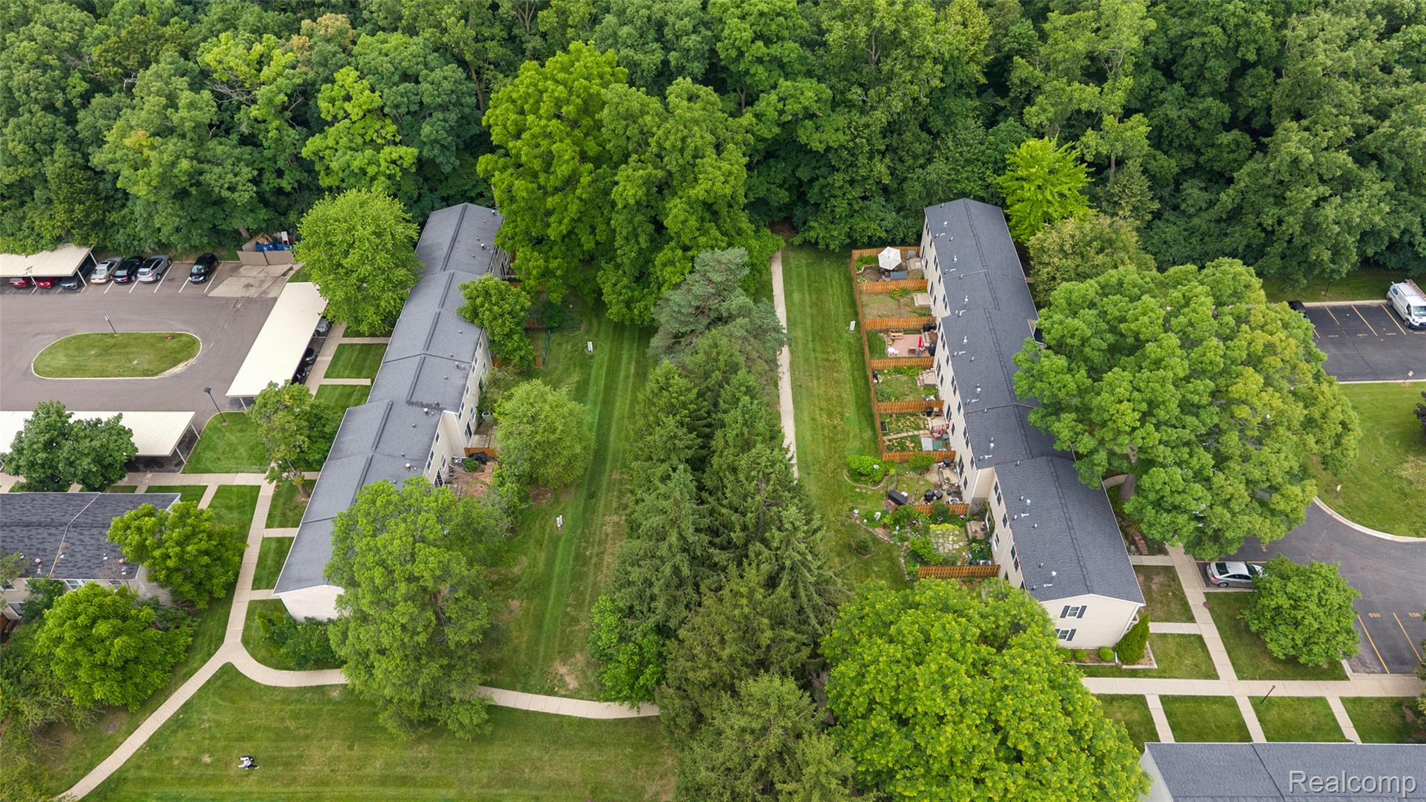 930 Little Hill Court Rochester, MI 48307 - Photo 17 of 38 Aerial perspective showcasing multiple residential buildings nestled within abundant mature trees