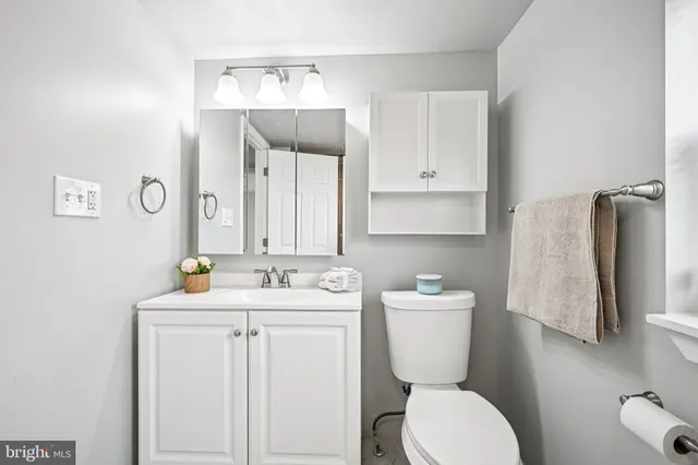 a bathroom with a toilet sink and mirror