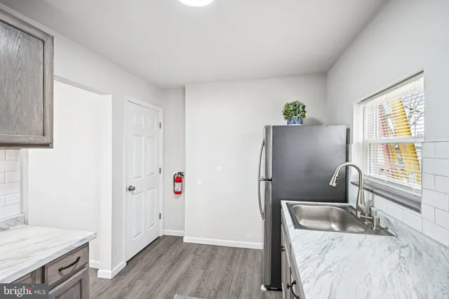 a kitchen with stainless steel appliances granite countertop a refrigerator and a sink