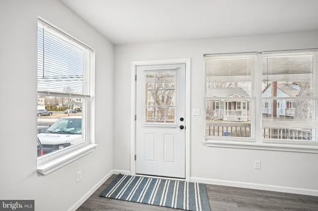 a view of wooden floor and windows in a room
