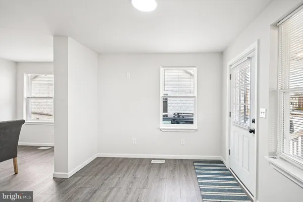 a view of a room with wooden floor and windows