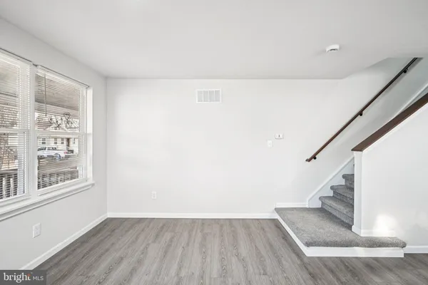 a view of entryway with wooden floor and stairs