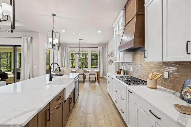 a spacious bedroom with a large bed and a chandelier