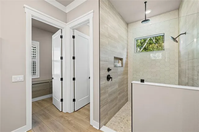 a bedroom with bed and wooden floor